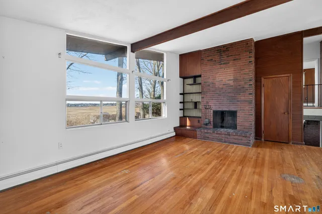 a view of a livingroom with wooden floor and closet
