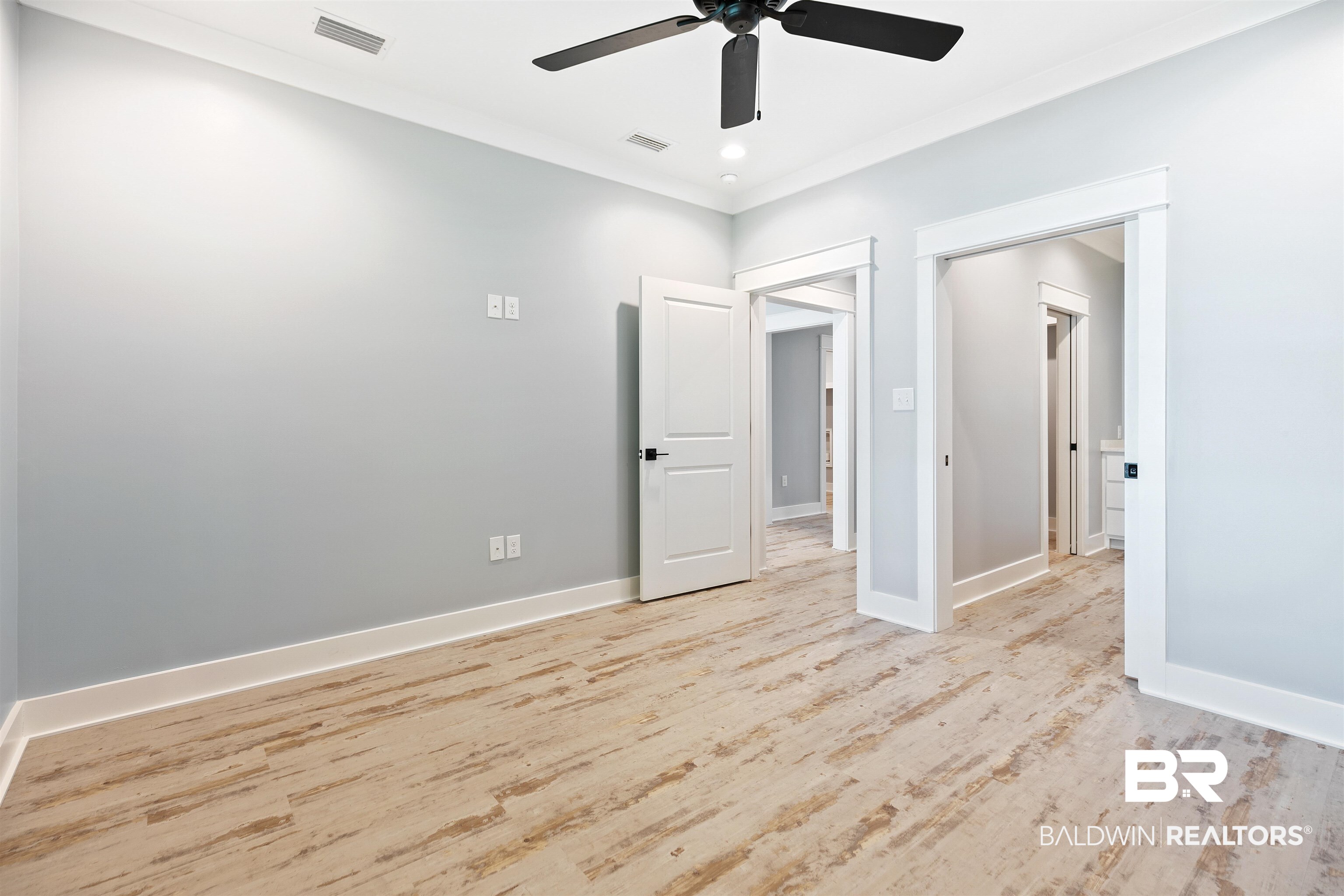 10507 County Road 1 Fairhope, AL 36532 - Photo 26 of 59 Unfurnished bedroom with light hardwood / wood-style flooring, ceiling fan, and crown molding