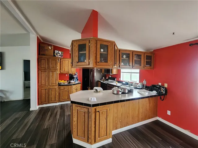 a kitchen with a sink refrigerator and cabinets