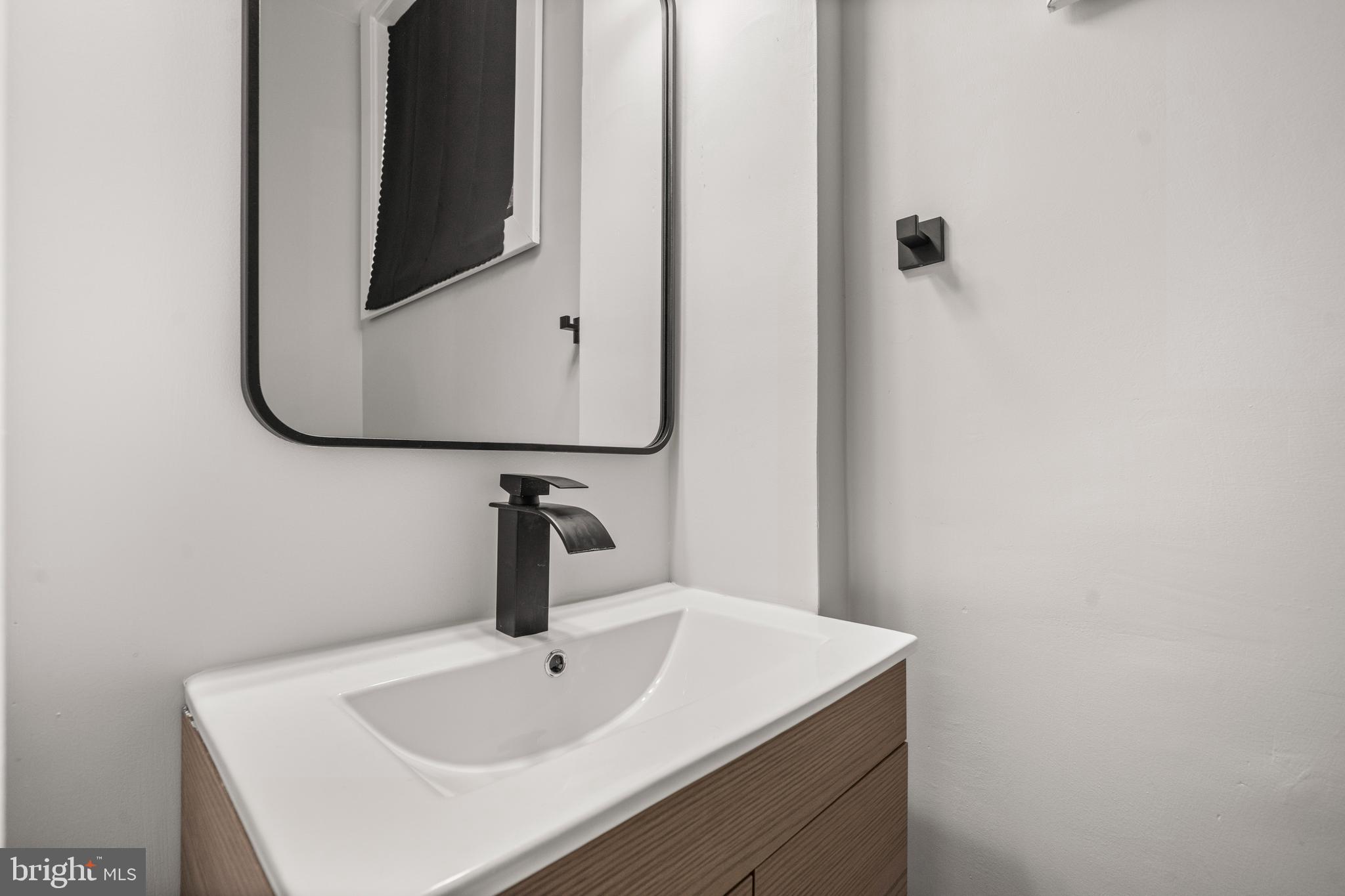 3707 Dunlap Street Temple Hills, MD 20748 - Photo 12 of 30 a bathroom with a sink and mirror