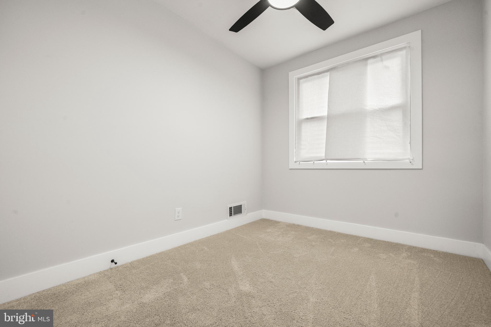 3707 Dunlap Street Temple Hills, MD 20748 - Photo 16 of 30 an empty room with windows and chandelier fan