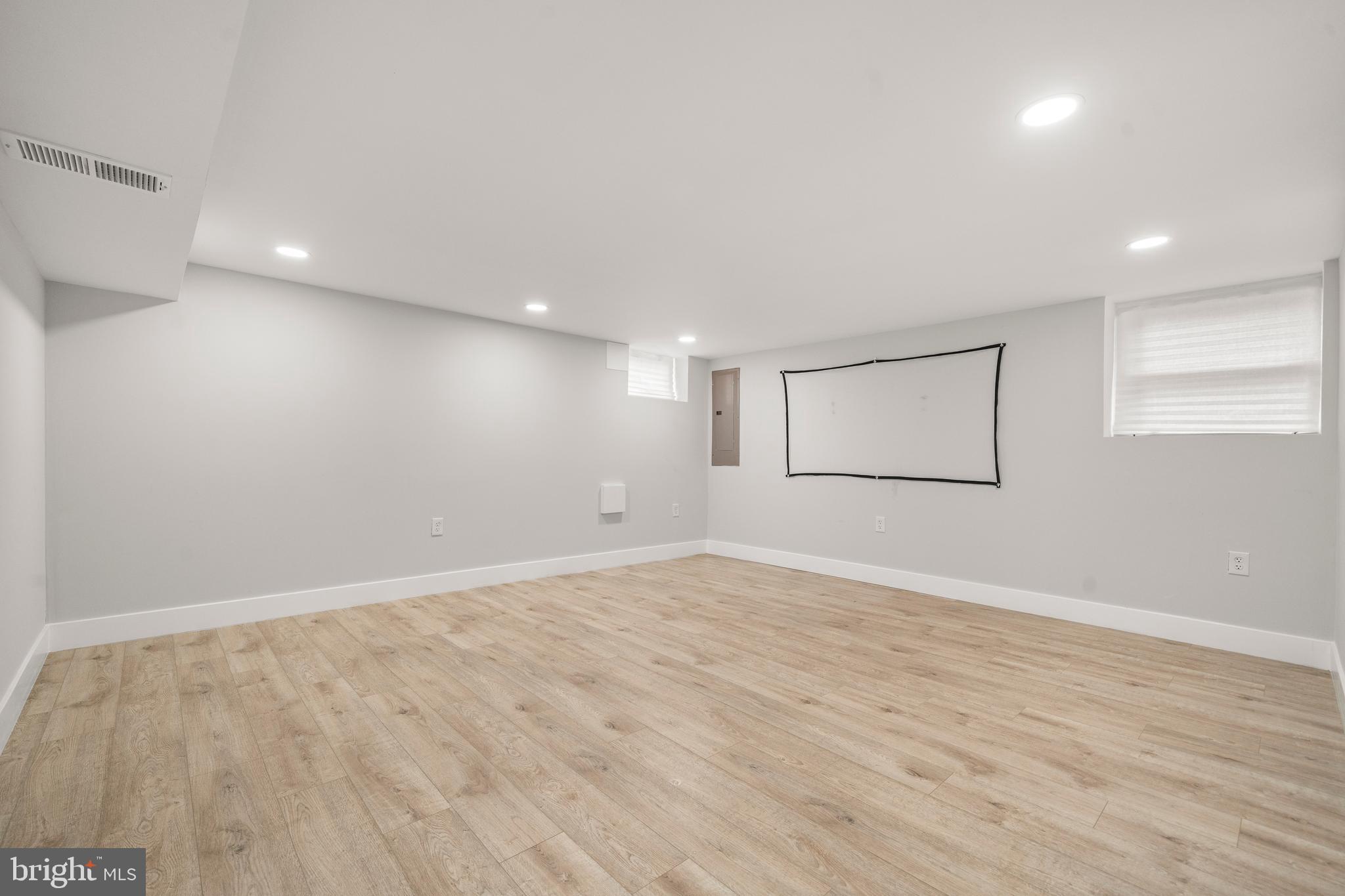 3707 Dunlap Street Temple Hills, MD 20748 - Photo 21 of 30 a view of an empty room with wooden floor and a window