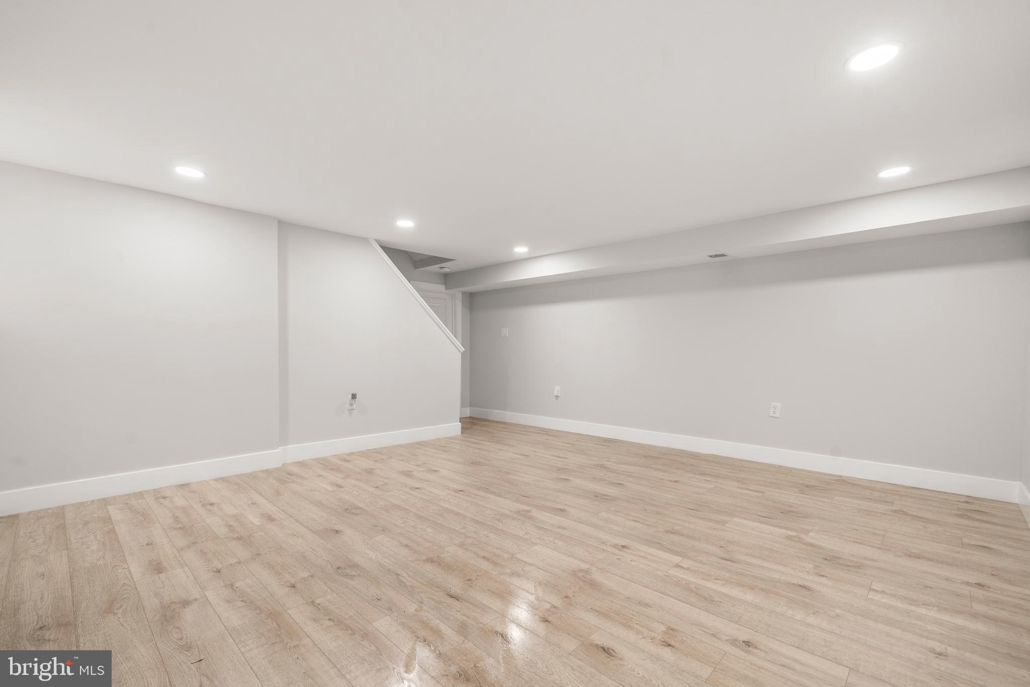 3707 Dunlap Street Temple Hills, MD 20748 - Photo 23 of 30 an empty room with wooden floor and windows