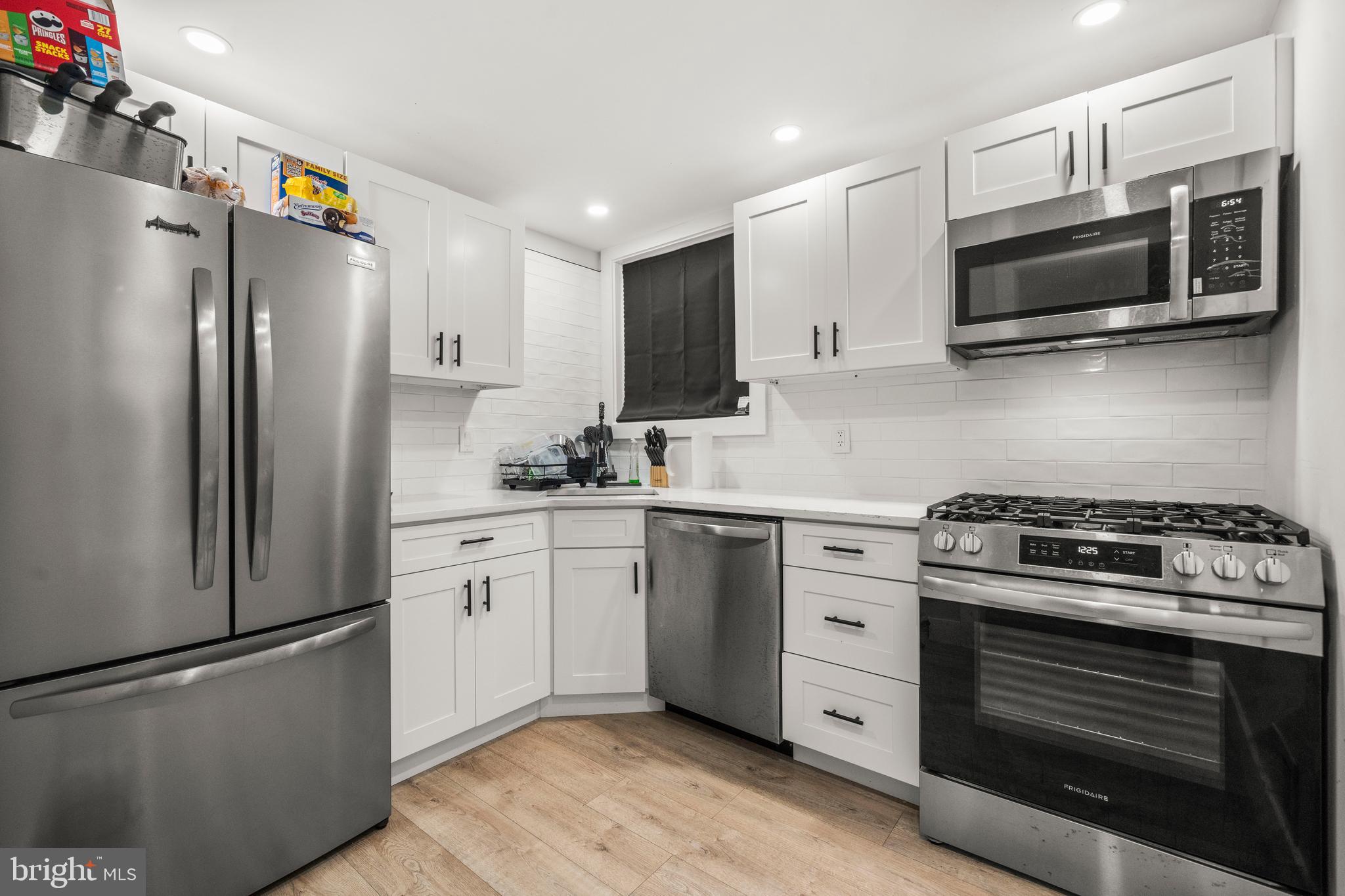 3707 Dunlap Street Temple Hills, MD 20748 - Photo 7 of 30 a kitchen with stainless steel appliances white cabinets and a stove top oven