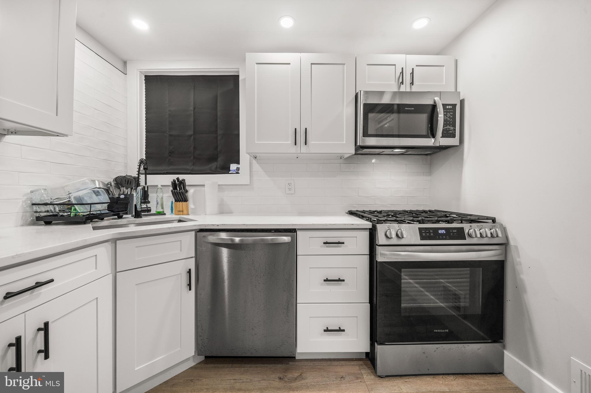 3707 Dunlap Street Temple Hills, MD 20748 - Photo 8 of 30 a kitchen with white cabinets and stainless steel appliances