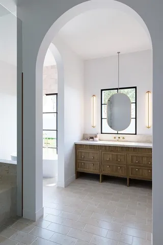 a bathroom with a double vanity sink and mirror
