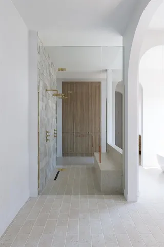 a view of a hallway with wooden shelves