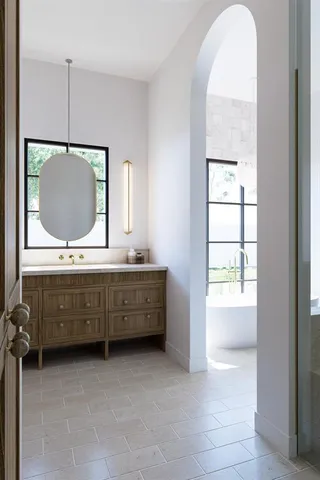 a room with two mirror and a window