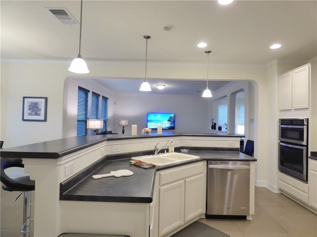 1216 Yellow Iris Road Leander, TX 78641 - Photo 11 of 33 a kitchen with a sink stove and cabinets