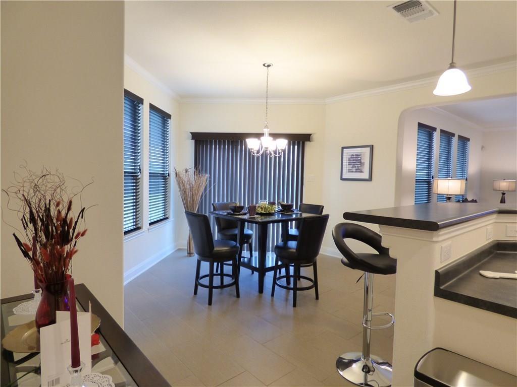 1216 Yellow Iris Road Leander, TX 78641 - Photo 14 of 33 a view of a dining room with furniture and chandelier