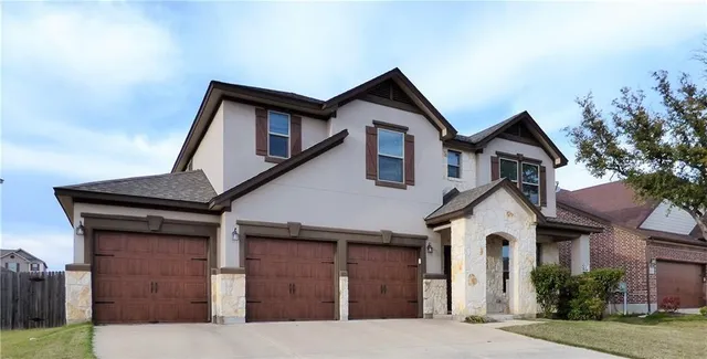 a view of house and a yard