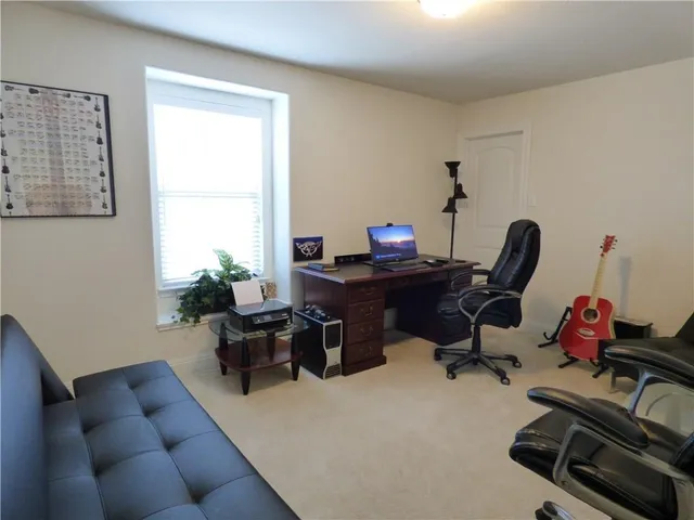 a living room with furniture a air conditioner vent and a window