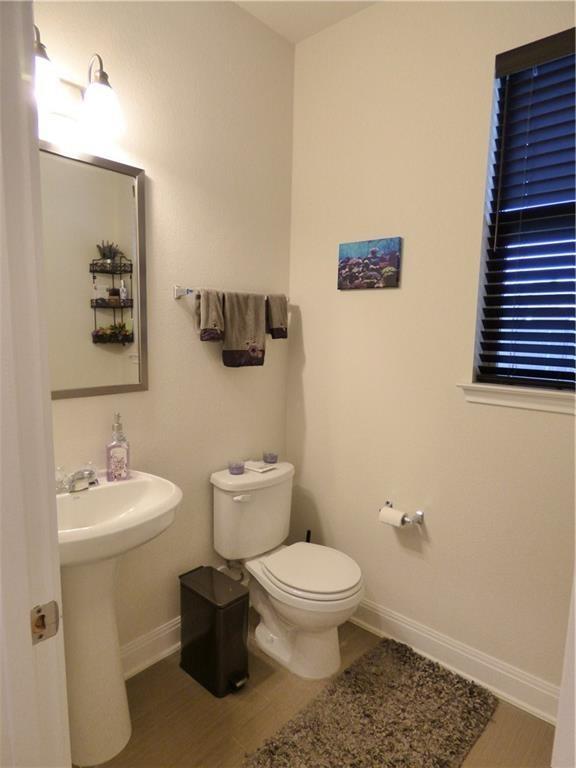 1216 Yellow Iris Road Leander, TX 78641 - Photo 27 of 33 a bathroom with a toilet a sink and mirror