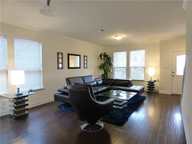 a living room with furniture and wooden floor