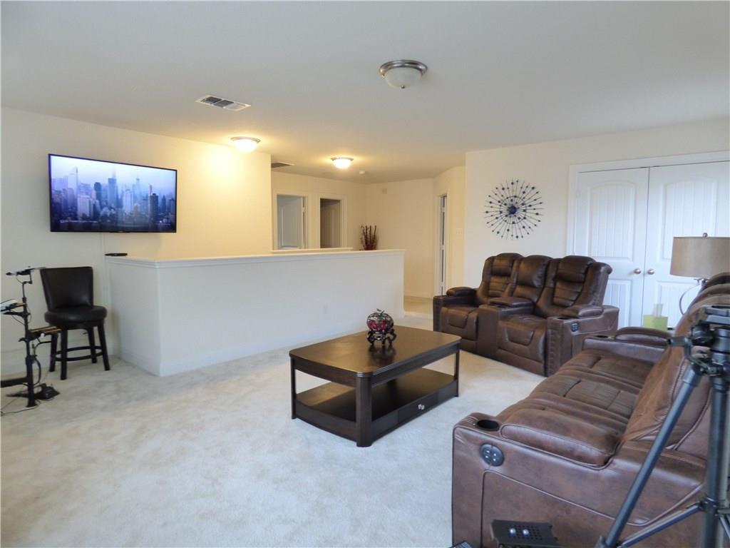 1216 Yellow Iris Road Leander, TX 78641 - Photo 31 of 33 a living room with furniture and a couch
