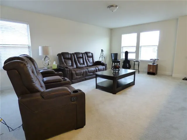 a living room with furniture window and a fireplace