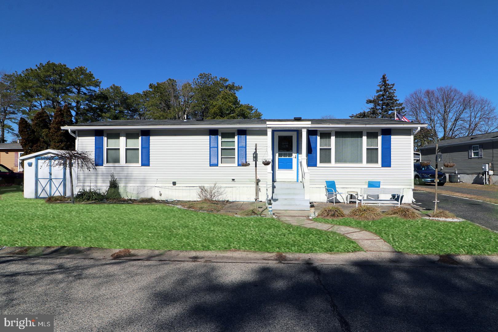 a front view of a house with a garden and yard