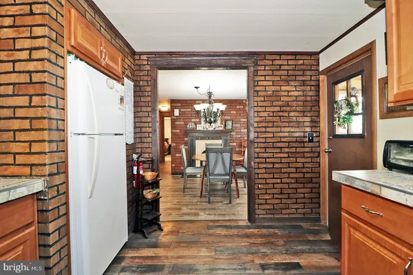 a view of a hallway with a dining table and chairs