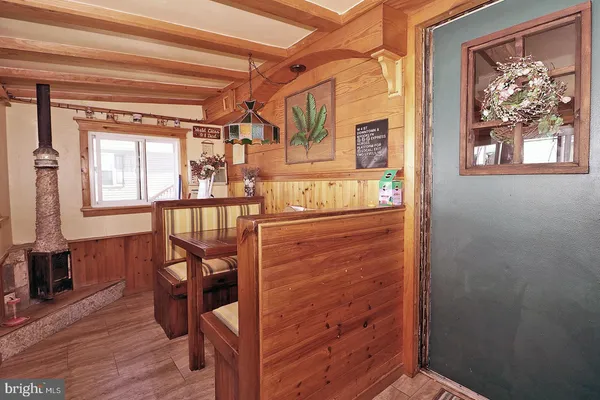a view of a hallway with wooden floor and a window