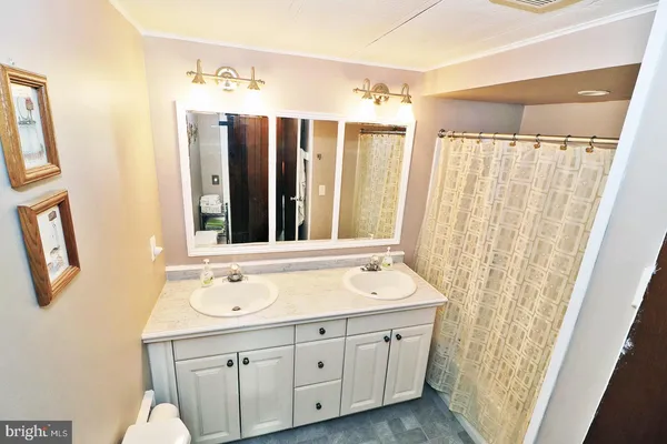 a bathroom with a double vanity sink and mirror