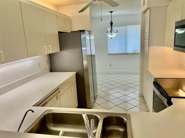 a kitchen with a refrigerator and a sink