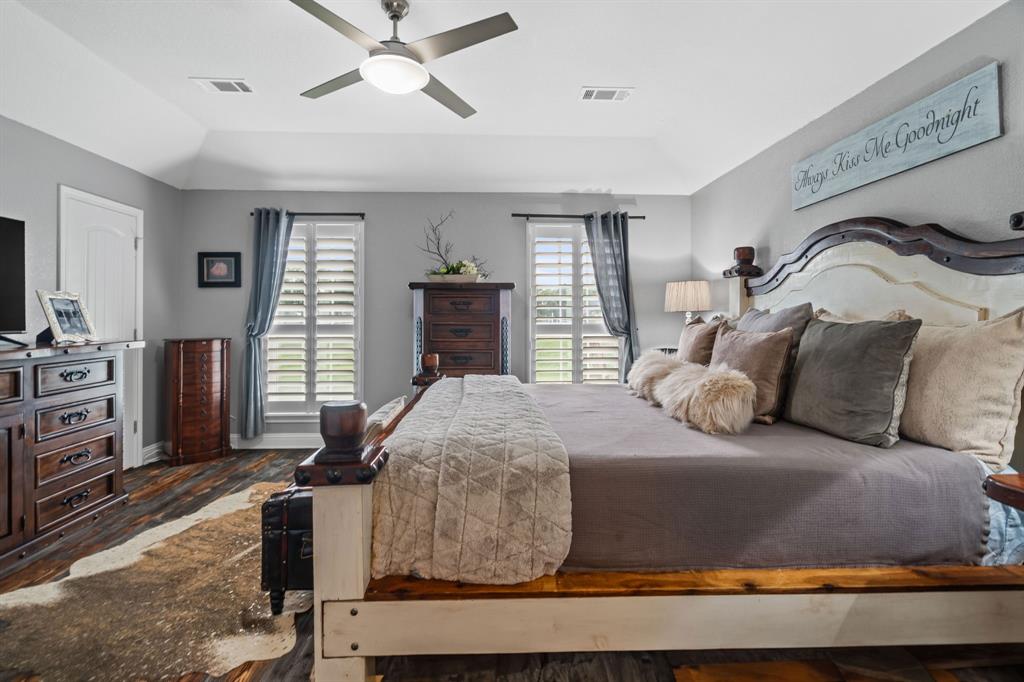 175 Porter Road Bartonville, TX 76226 - Photo 19 of 40 a bedroom with a bed and dresser with mirror