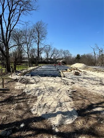 a view of a yard with snow on the road