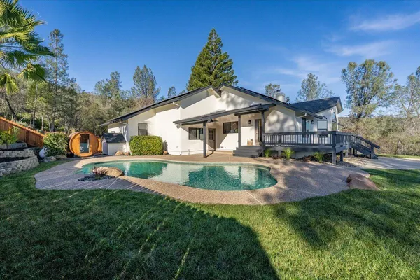 a view of a house with a yard patio and sitting area