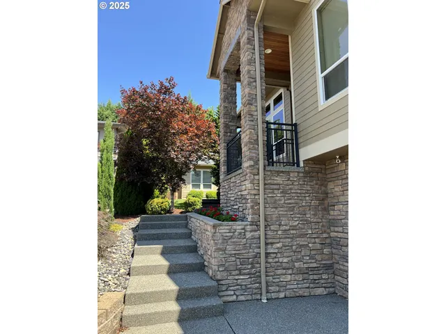 a pathway of a house with a yard