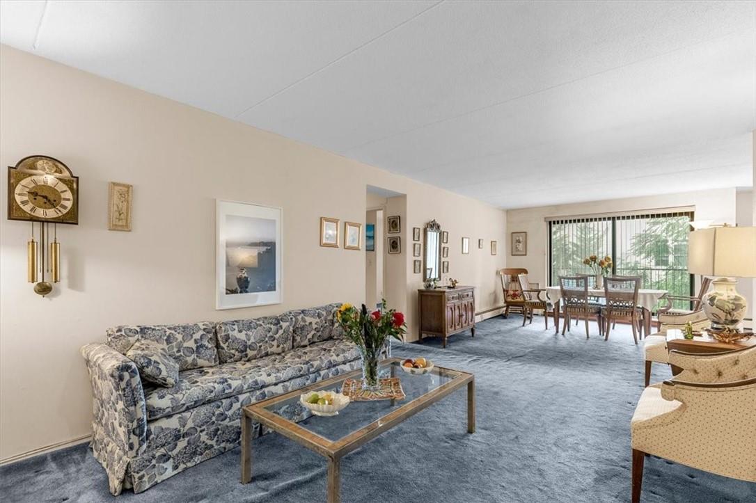 108 Sagamore Road, Unit 3J Tuckahoe, NY 10707 - Photo 1 of 1 a living room with furniture and a large window