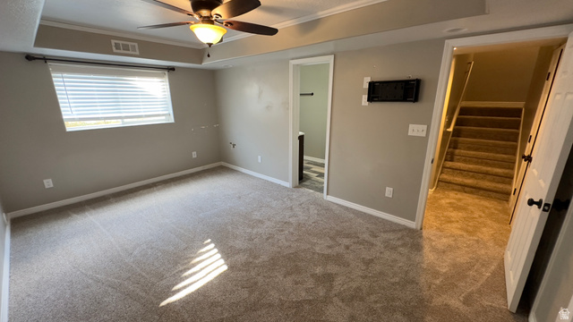 3547 East Golden Eagle Road Eagle Mountain, UT 84005 - Photo 28 of 47 Unfurnished bedroom featuring a tray ceiling, carpet floors, crown molding, and ceiling fan