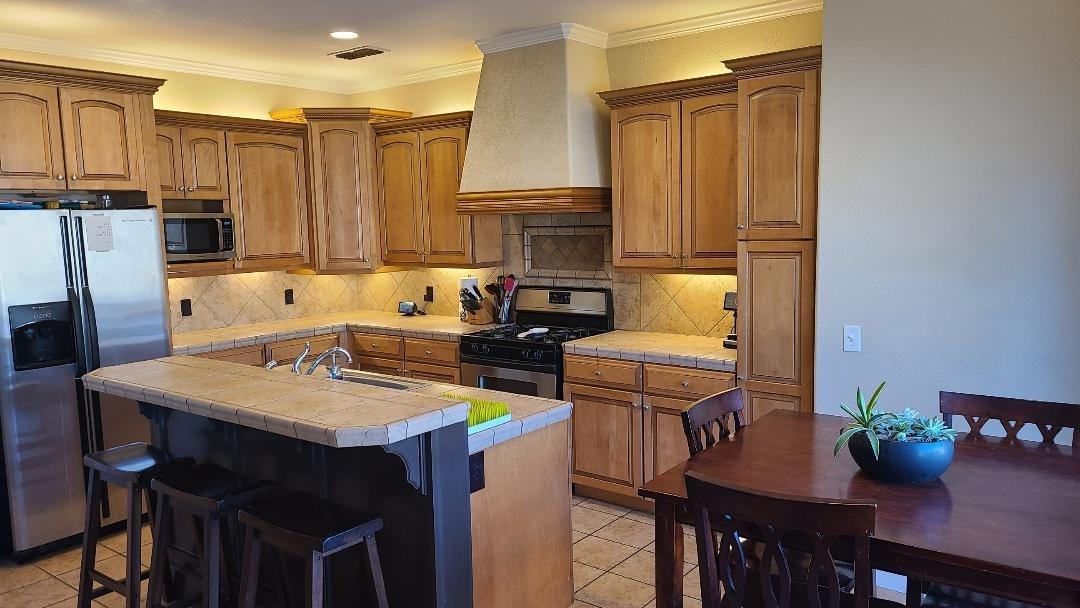 28937 Auberry Road Prather, CA 93651 - Photo 3 of 6 a kitchen with a sink refrigerator and cabinets