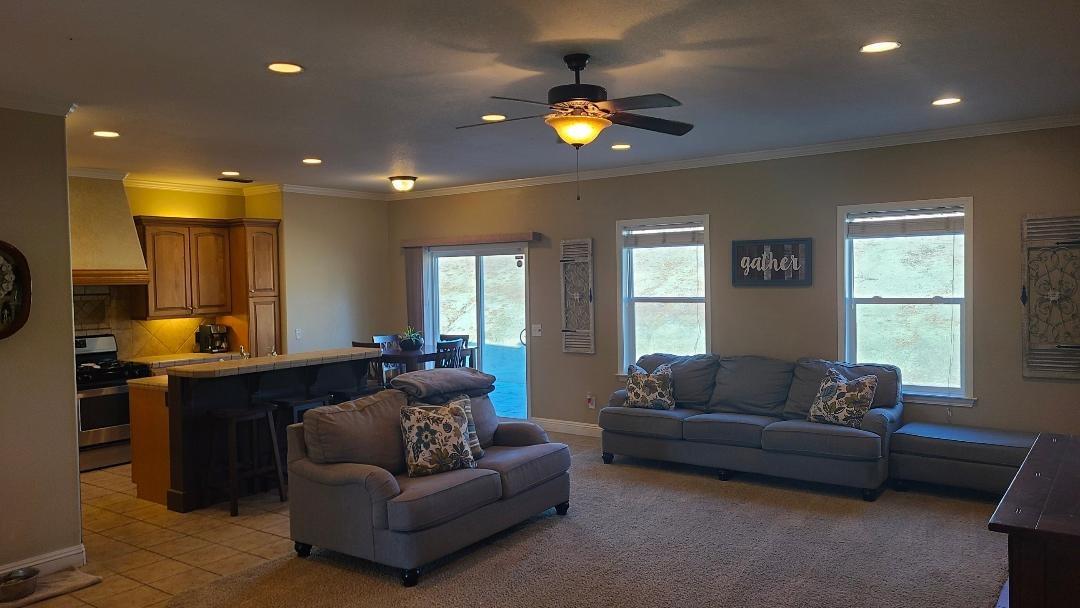 28937 Auberry Road Prather, CA 93651 - Photo 5 of 6 a living room with furniture and a chandelier