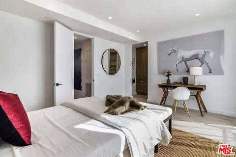 a bedroom with a bed and a chair