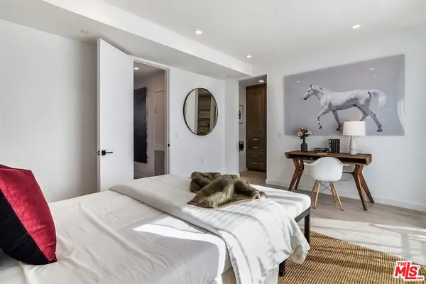 a bedroom with a bed and a chair
