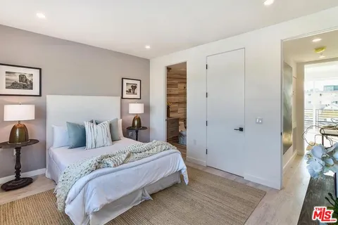 a bedroom with a bed and a table