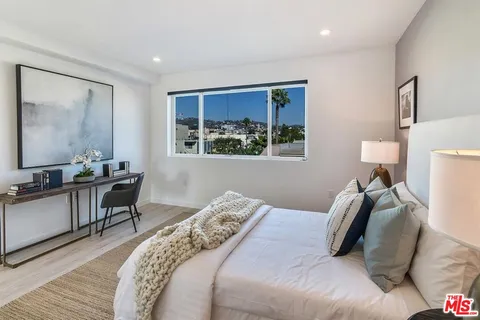 a bedroom with bed and a window