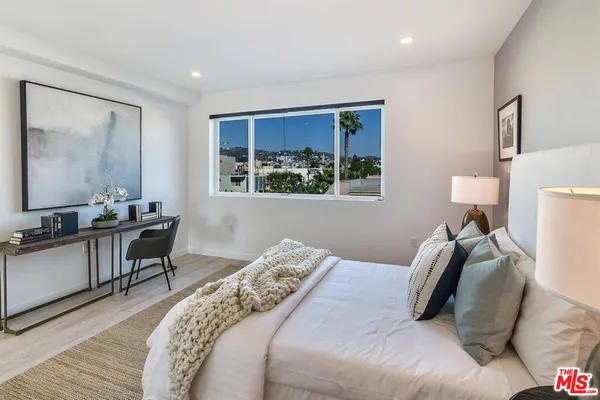 a bedroom with bed and a window
