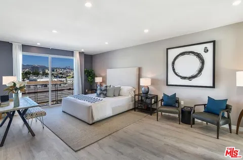 a living room with furniture and a large mirror