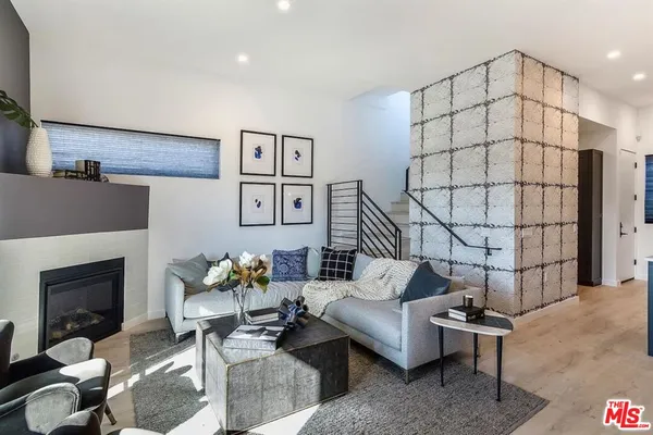 a living room with furniture a rug and a fireplace