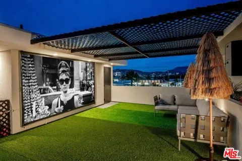 a view of a backyard with a patio and outdoor seating