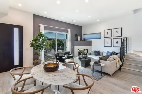 a living room with furniture potted plant and a window