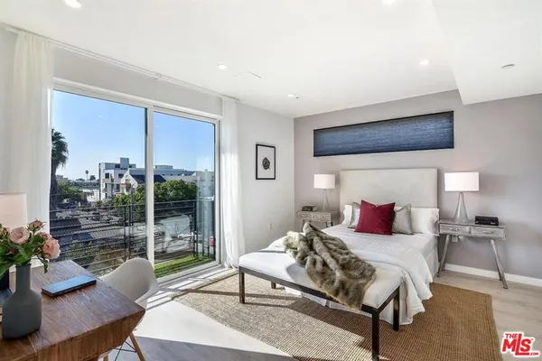 a bedroom with a bed and a night stand