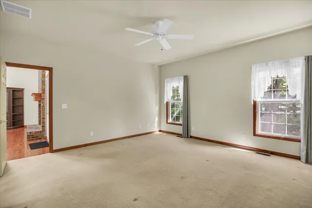 an empty room with windows and closet