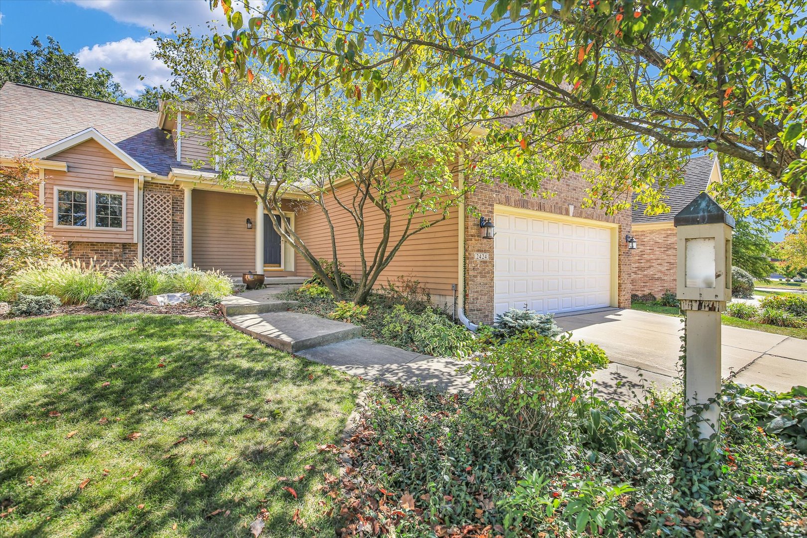 2424 Prairie Ridge Place Champaign, IL 61822 - Photo 2 of 48 a front view of a house with garden