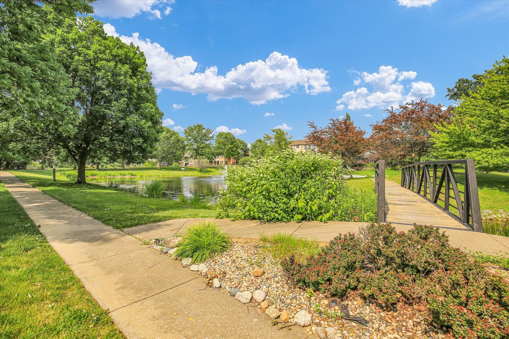 2424 Prairie Ridge Place Champaign, IL 61822 - Photo 25 of 48 a view of a street with a big yard and palm trees