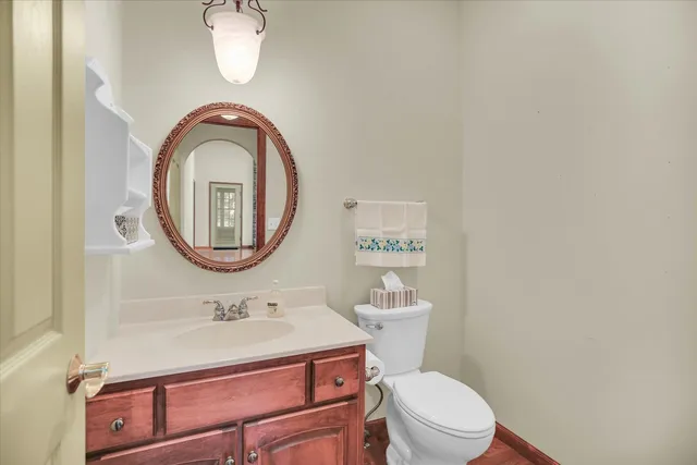 a bathroom with a sink a mirror a toilet and a sink