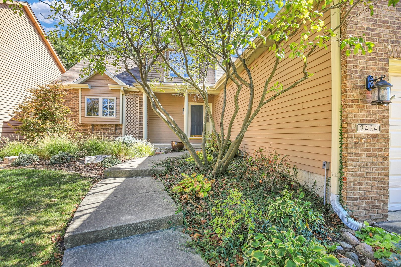 2424 Prairie Ridge Place Champaign, IL 61822 - Photo 3 of 48 a front view of a house with garden