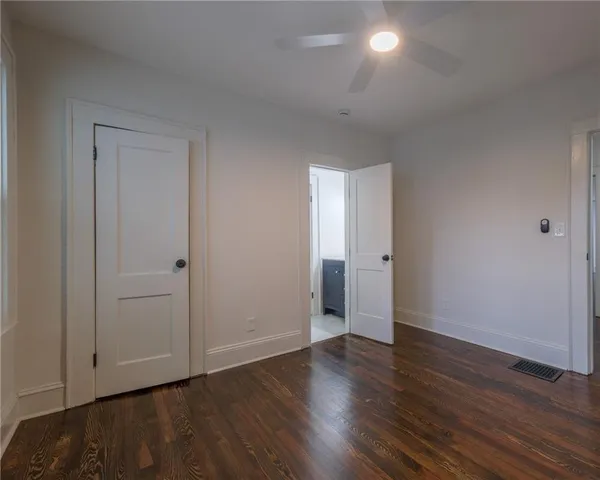 a view of an empty room with wooden floor