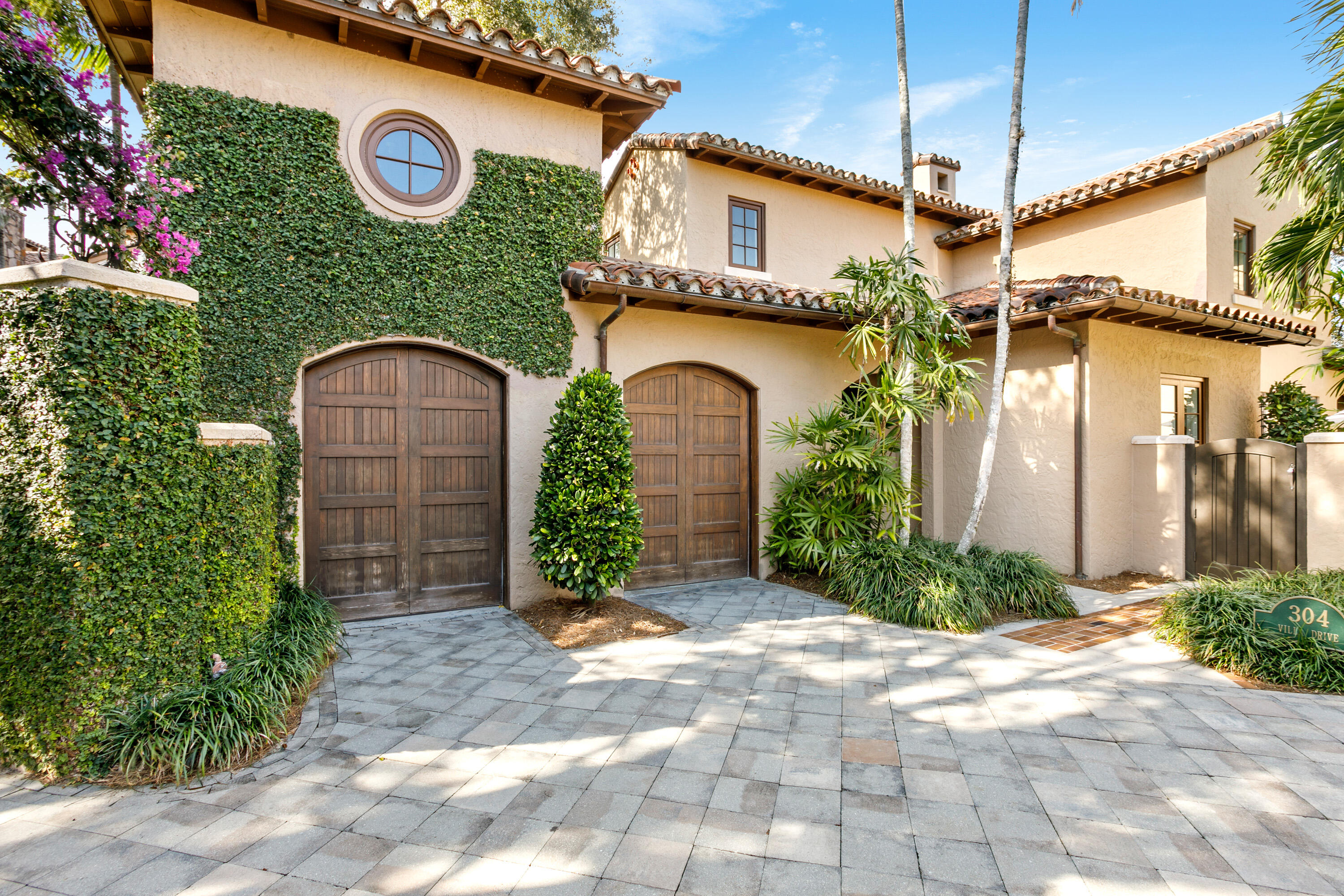 304 Villa Drive Jupiter, FL 33477 - Photo 1 of 43 a front view of a house with garden
